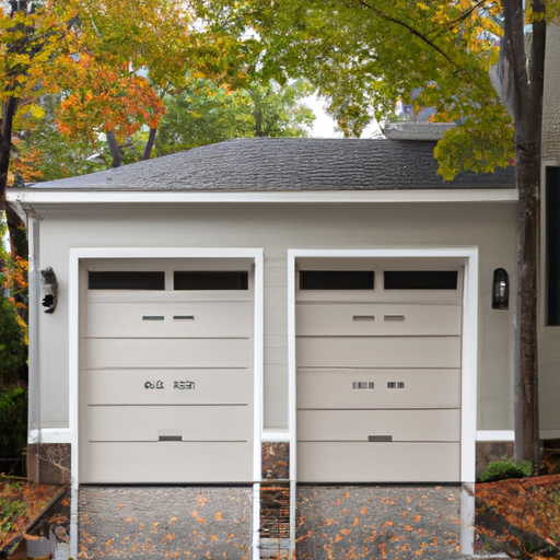 Suburban Wyckoff driveway with a closed modern garage door and autumn trees in the background.